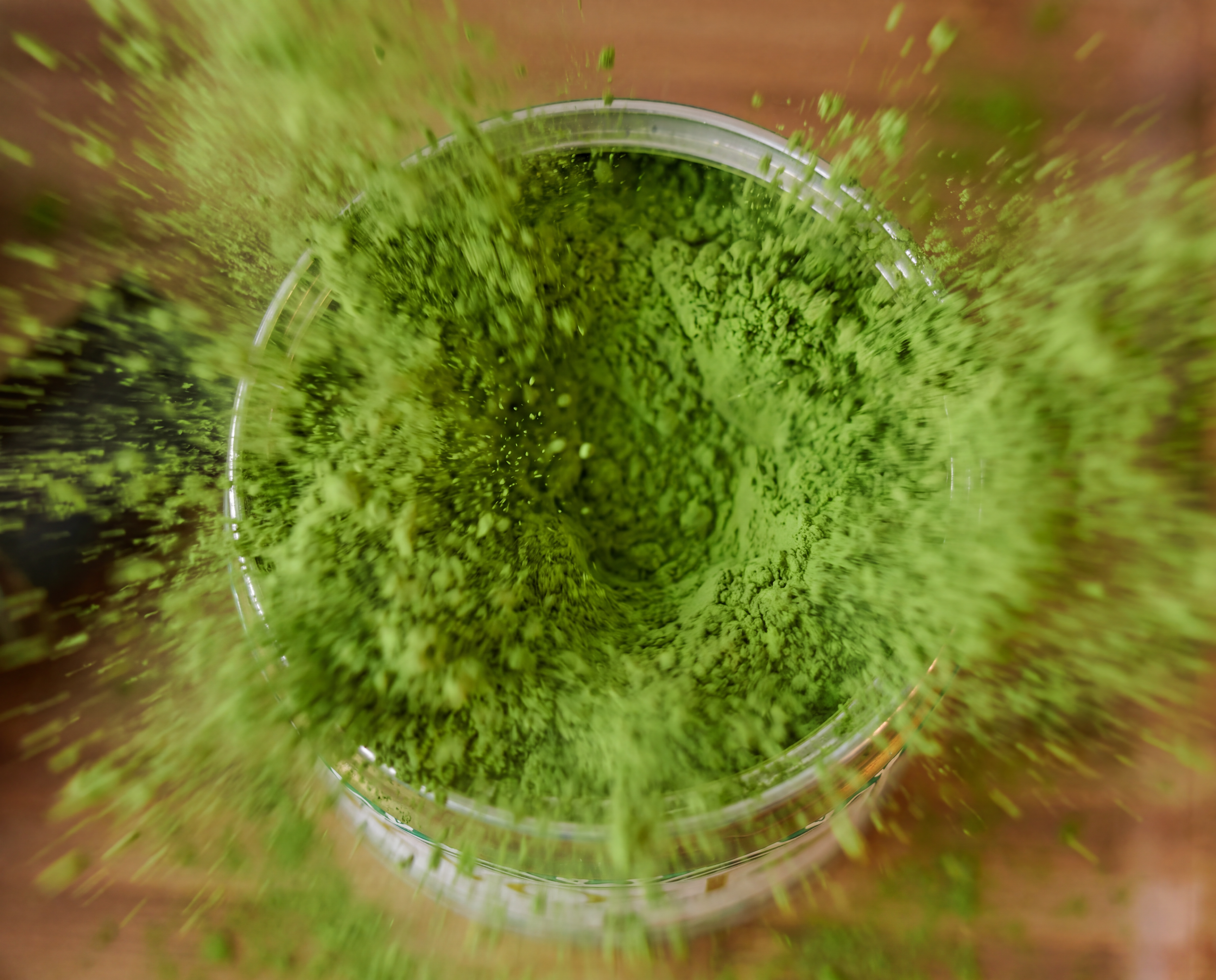 KYO-T Organic Matcha packaging with matcha powder exploding around the tin